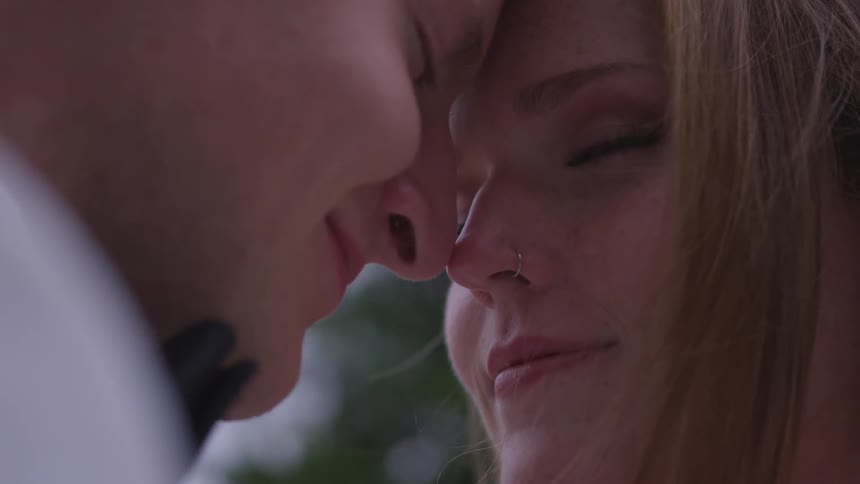 A couple touching their nose and head romantically