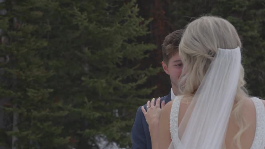 A bride and groom stand outside together
