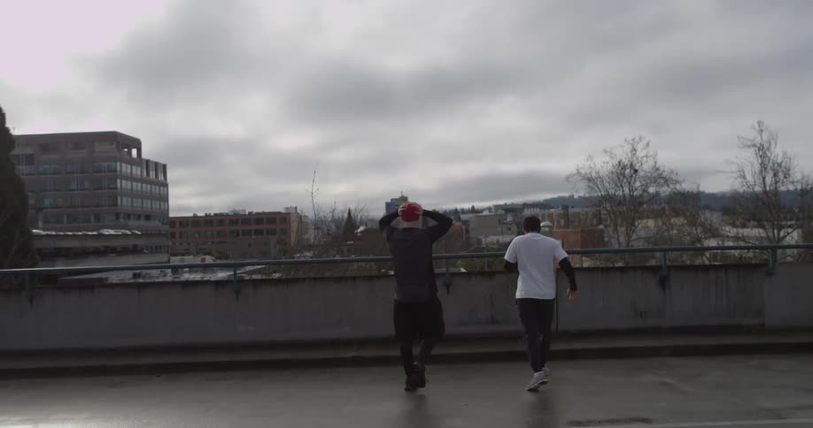 Two men jogging on a roof