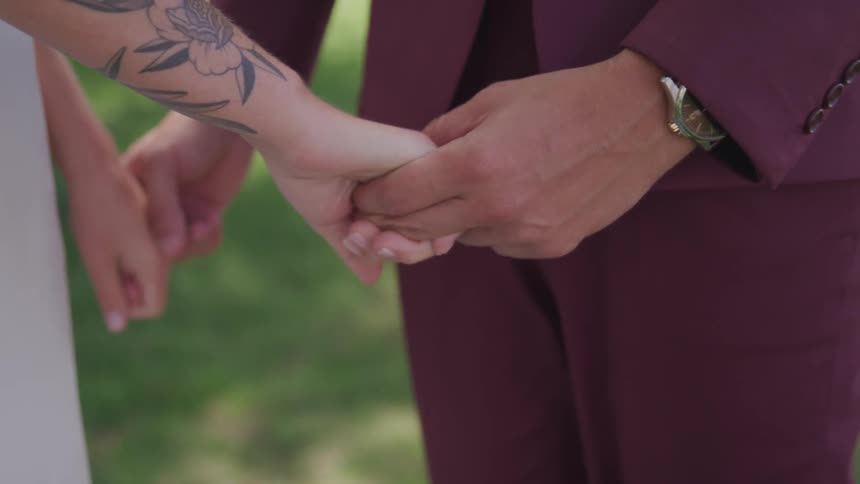 A man and woman hold hands