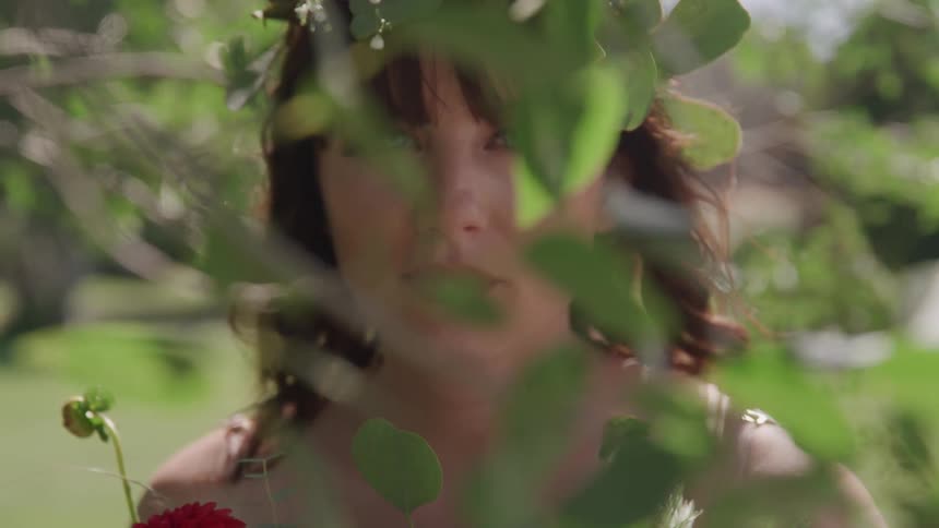 A woman behind a tree leaf