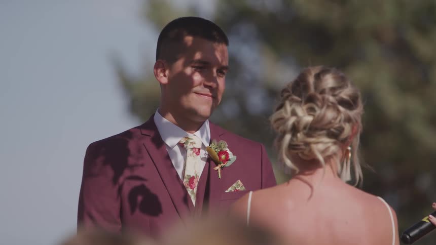 A couple stands together at a wedding