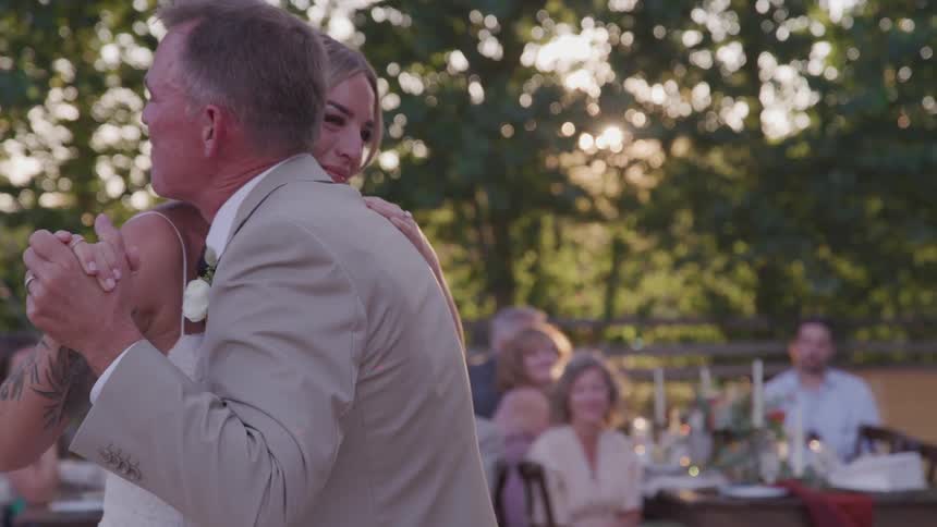 Bride dances with her father in front of the guests during the wedding ceremony