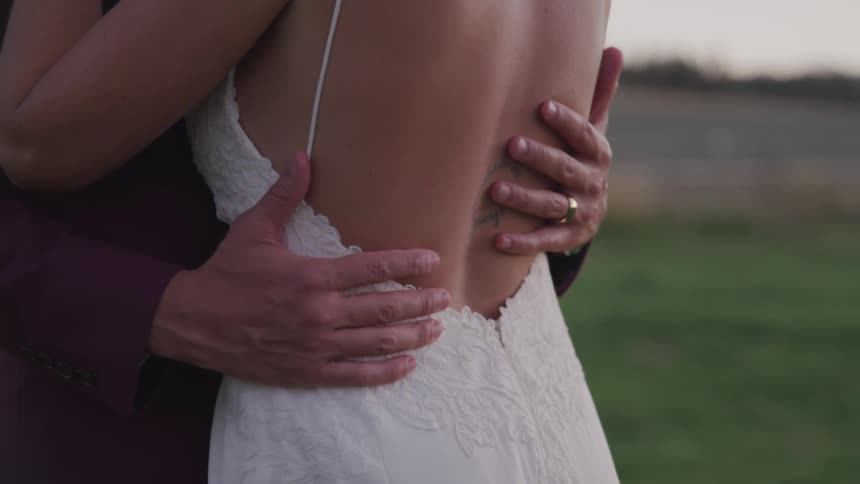 A bride is being held by her husband