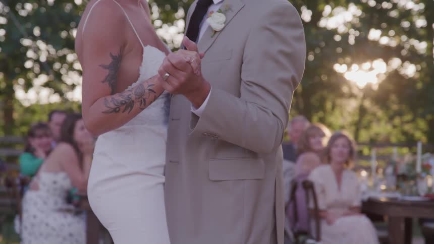 A bride and groom dance alone at their wedding