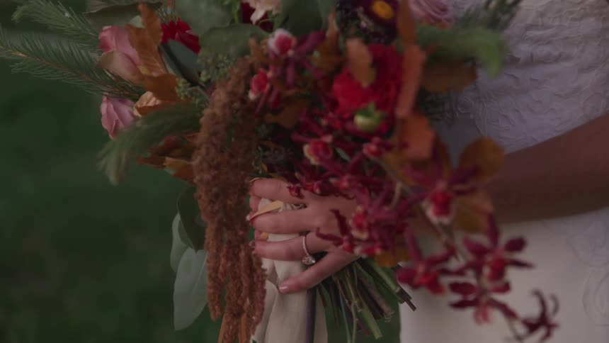 A bride holds her bouquet of flowers