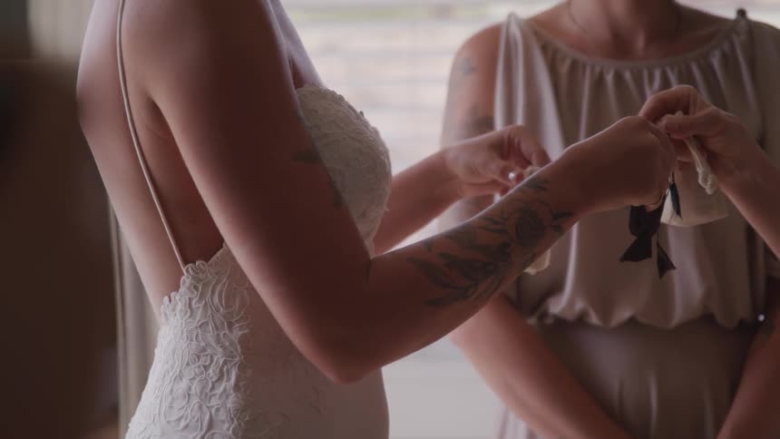 A bride and another person exchange small bags