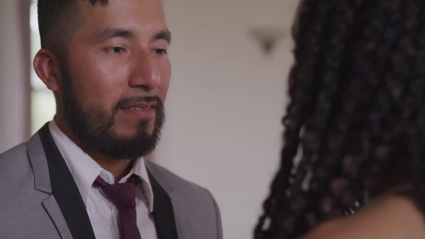 Groom looks at bride during the wedding ceremony