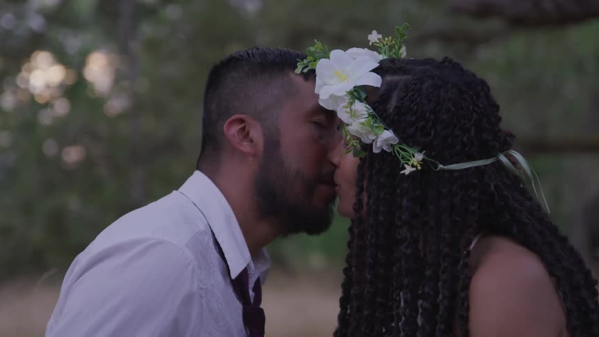 Groom and bride kisses each other during the wedding ceremony