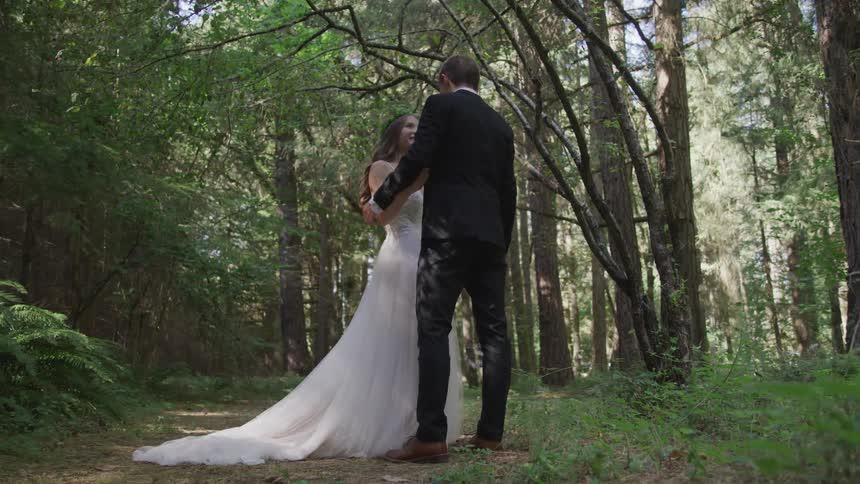 Married couple embracing and talking on forest
