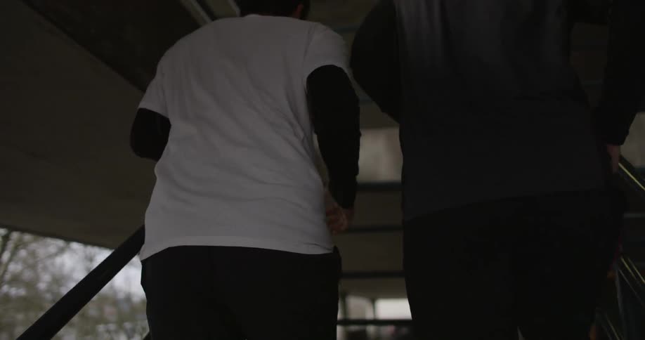 Two men jogging up stairs