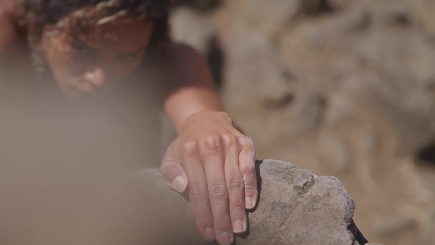 A young woman rock climbs