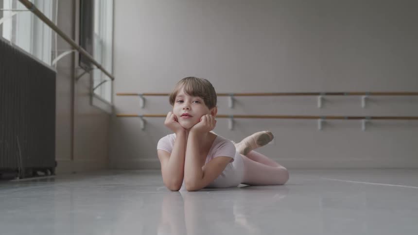 Ballet girl laying on the studio floor