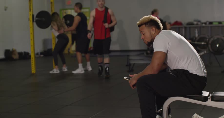 A man greets another man at the gym