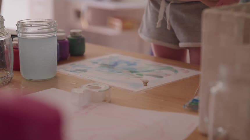 Child painting on table