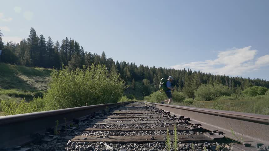 Hikers cross train tracks