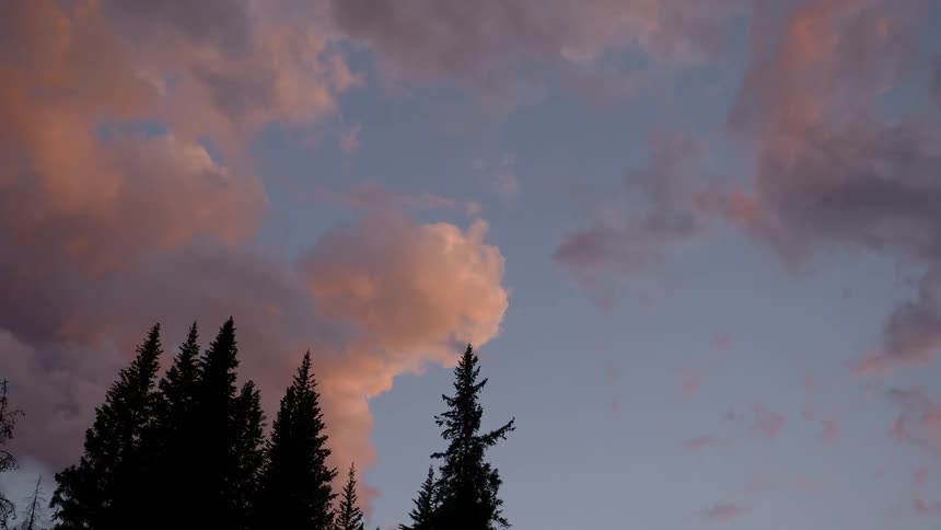 Clouds moving through the sky during sunset