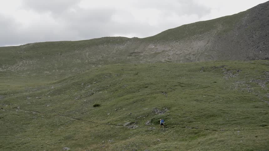 A person hikes across a field