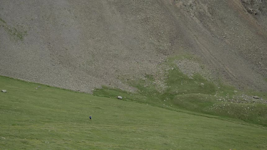Person goes down the green mountain