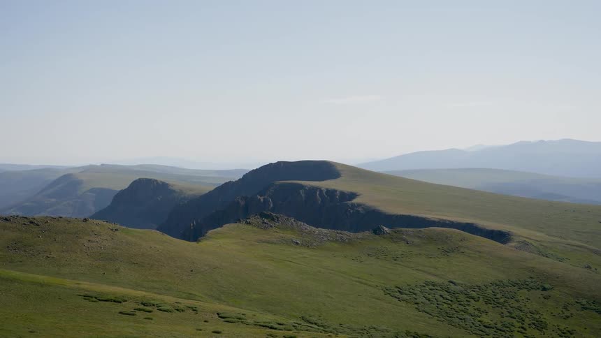 The gently sloping hills sit under a blue sky