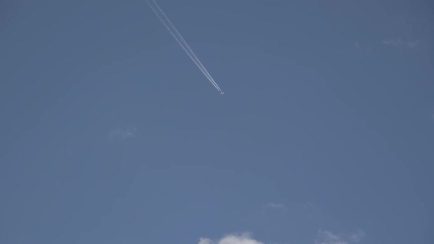 Jet flying across the sky leaving a white trail