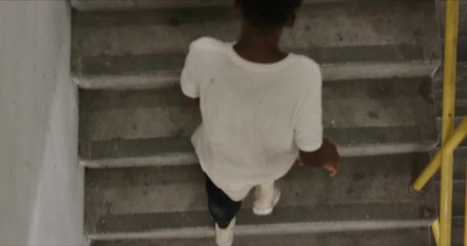 A black teen running upstair