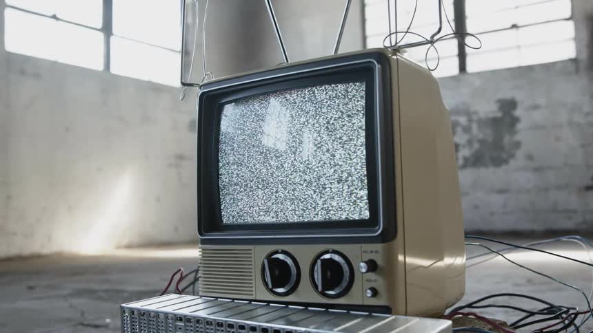 A tv with white noise showing until turned off