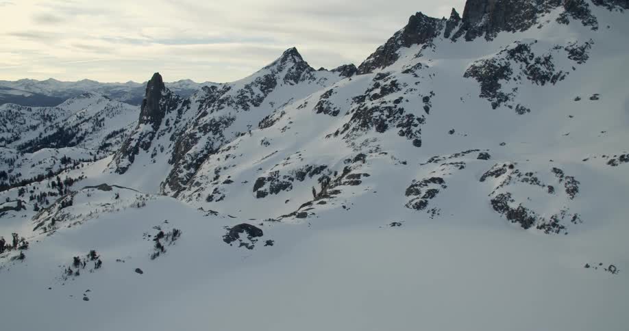 Clouds over a snow covered mountain ridge