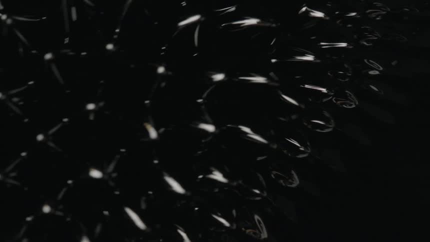 Light and reflection create patterns and movement in black