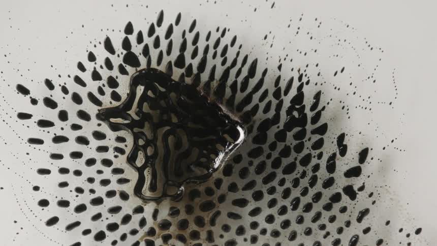 Oil separates as it flows through another liquid