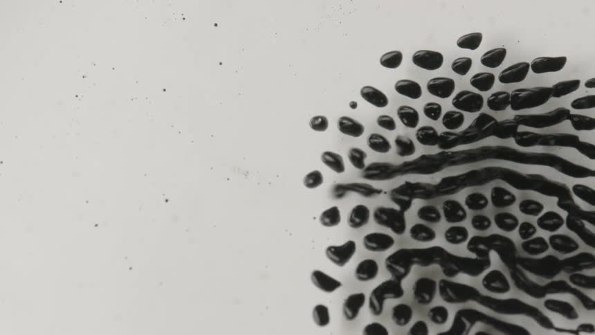 Black liquid runs across a white surface