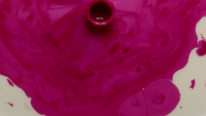 A pink paint dropped into the water