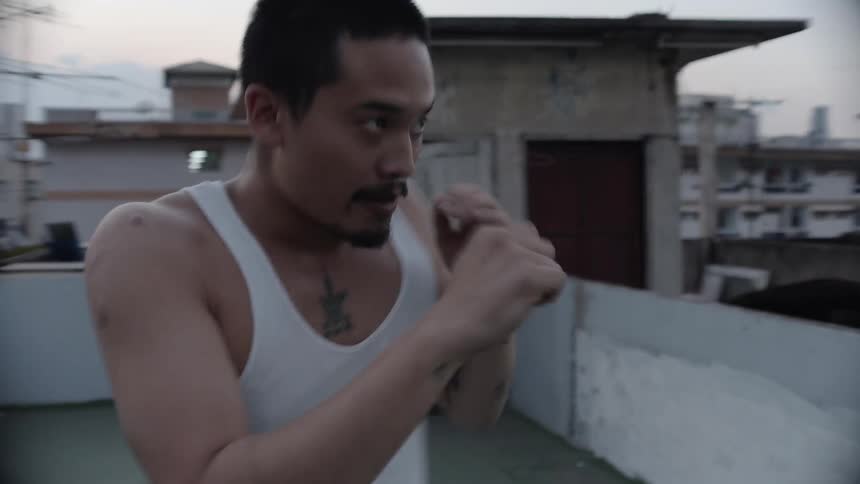 A man boxes on a rooftop