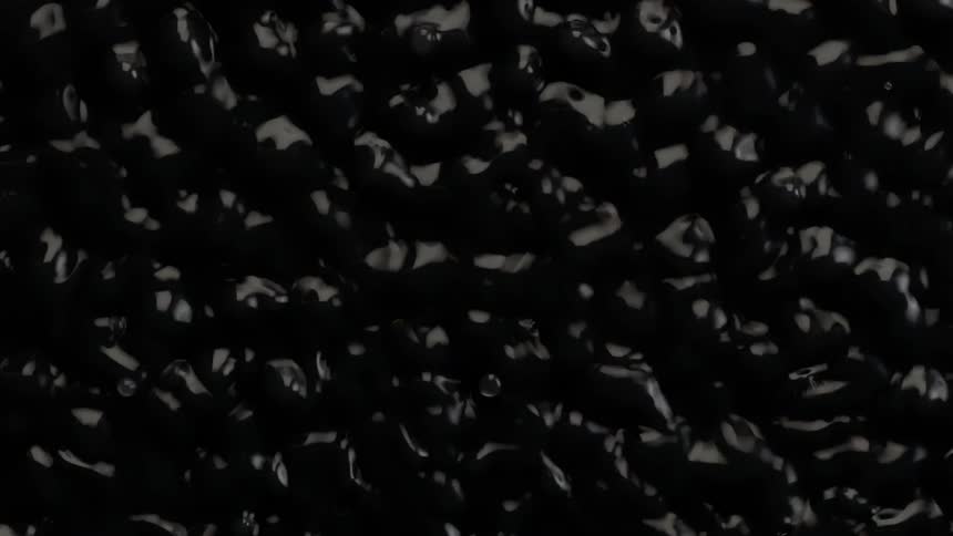 Black liquid shaking in a wave like pattern