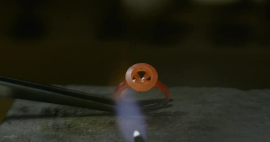 A flame forging an iron