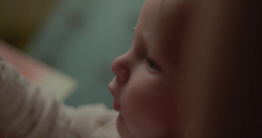 A baby is moving his arms around