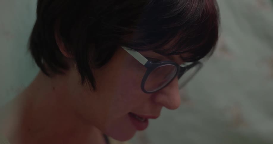 Close up of a woman wearing glasses talking