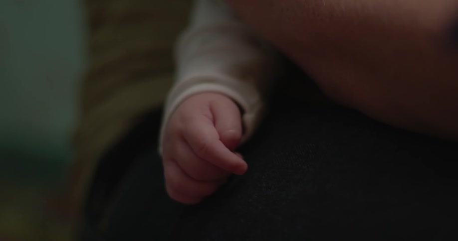 A close up of a babies hand moving