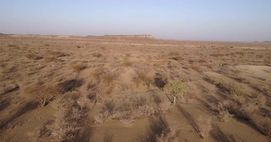 An aerial view of a rural desert area is displayed