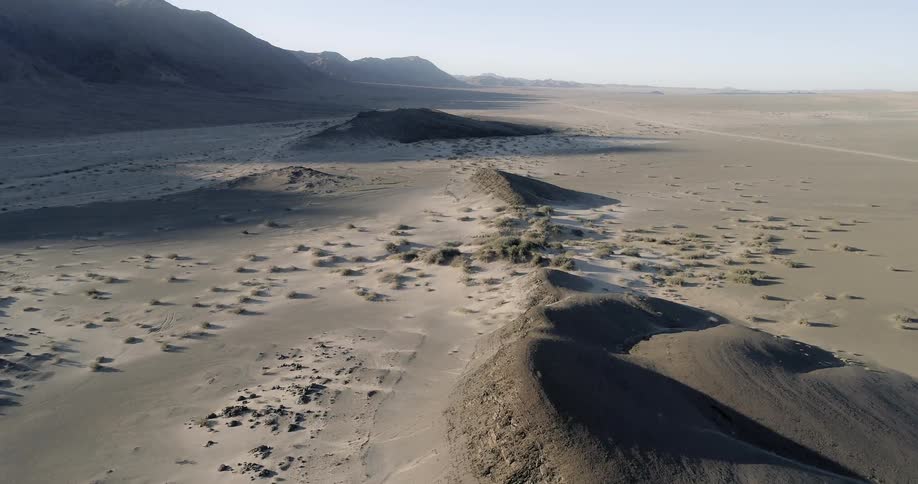 An aerial view of dunes in a sandy desert