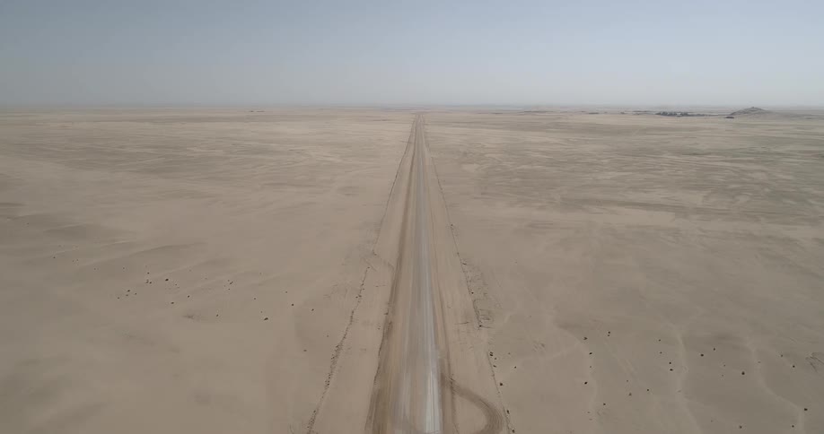 Theres a dirt road path in the horizon