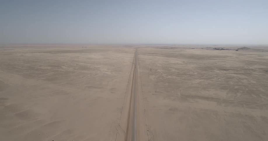 Aerial shot of cars on a road in the desert