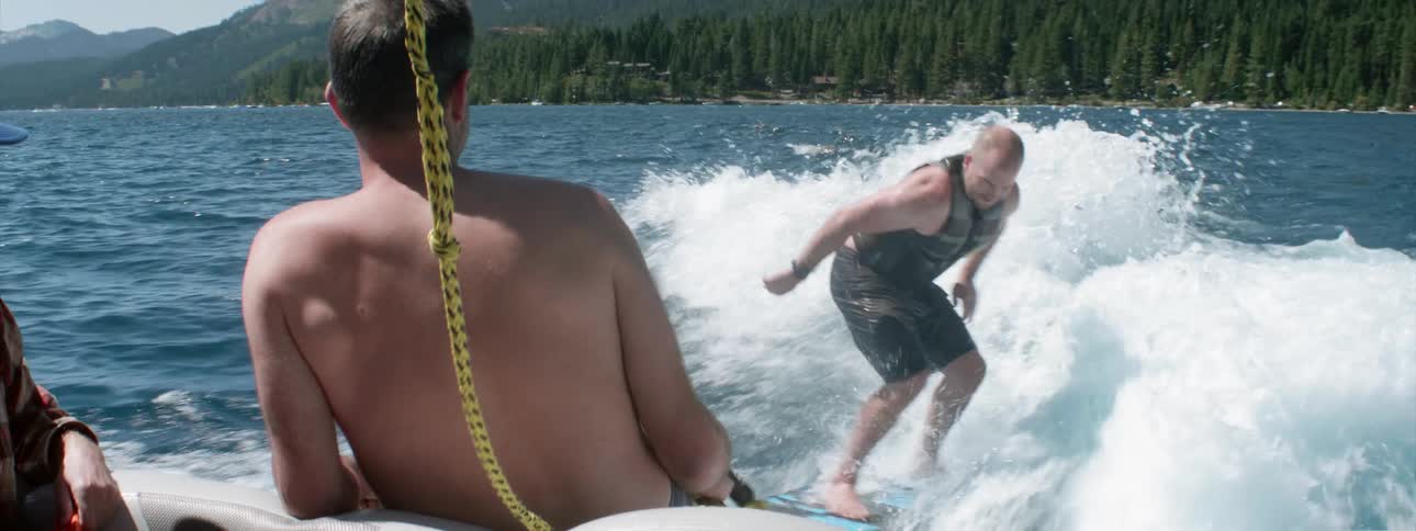 A man wakeboards behind a boat
