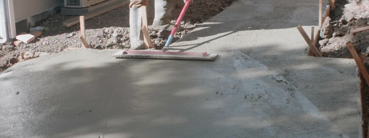A man smooths out cement