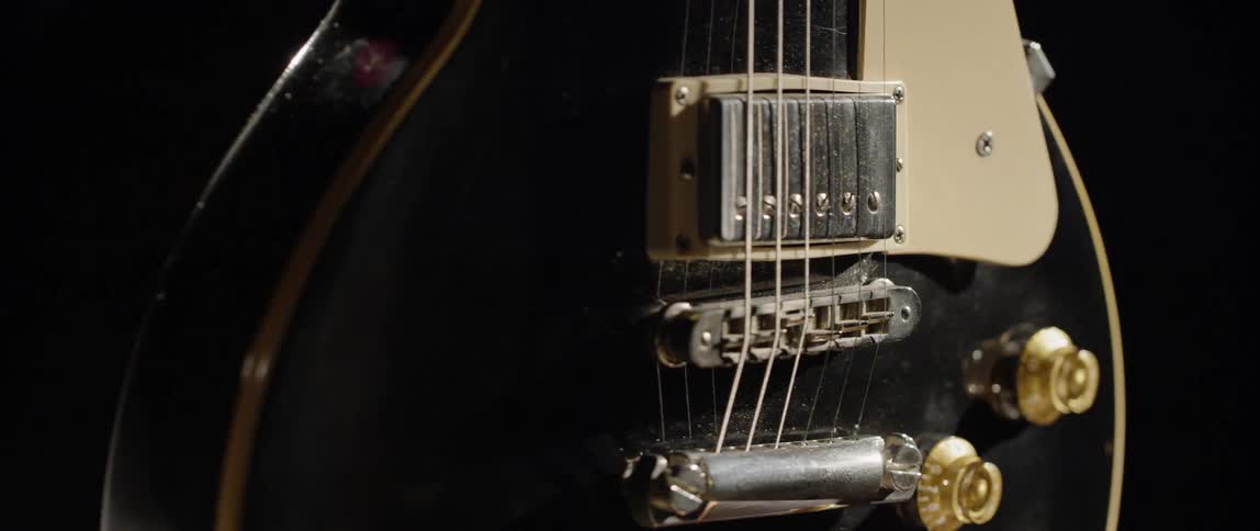 An electric guitar slowly spins around