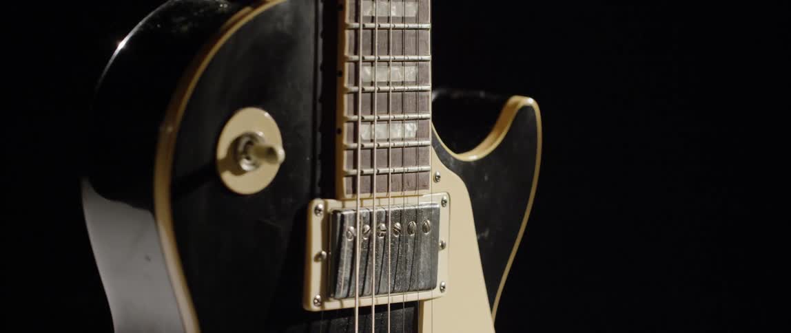 Close up a a guitar and its strings