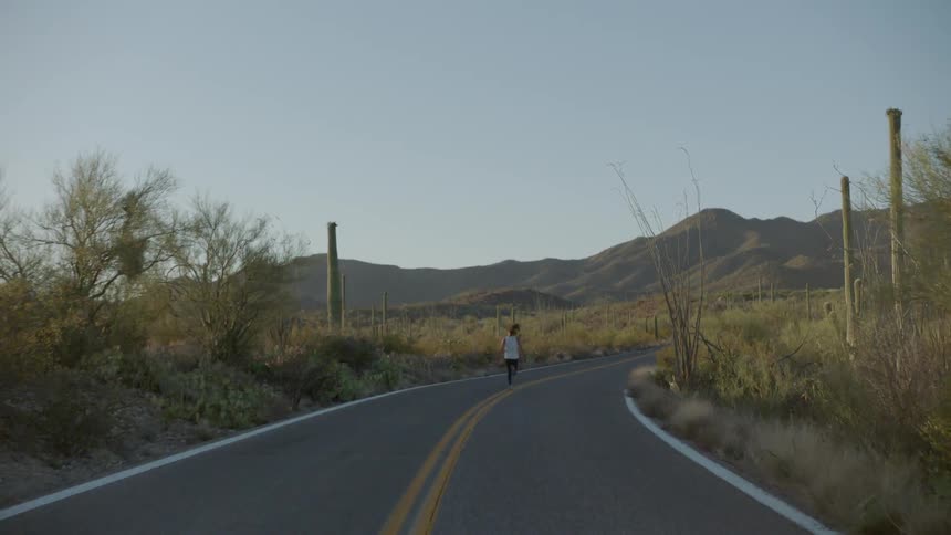 A woman running down a road