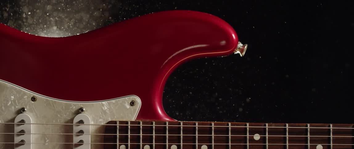 Dust swirls around an electric guitar