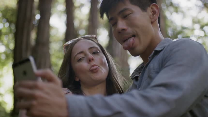People take a selfie in a forest
