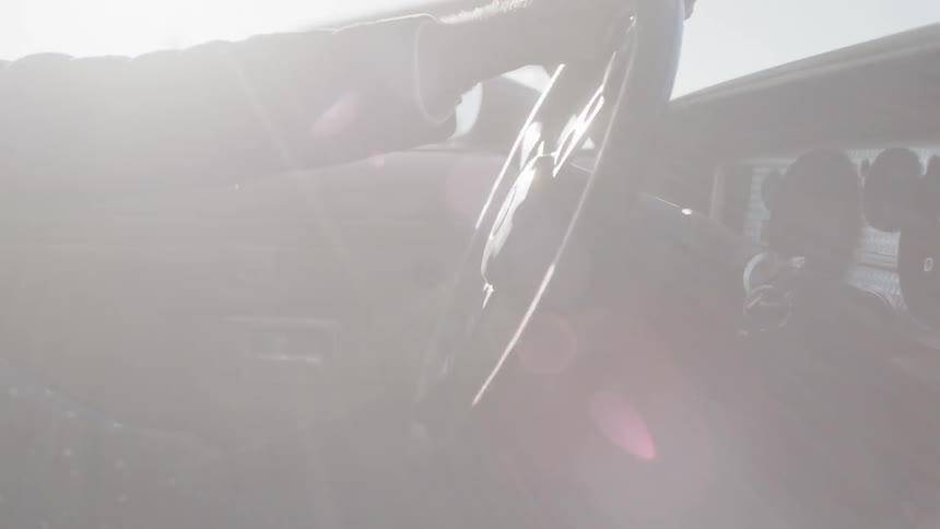 A woman is driving a car
